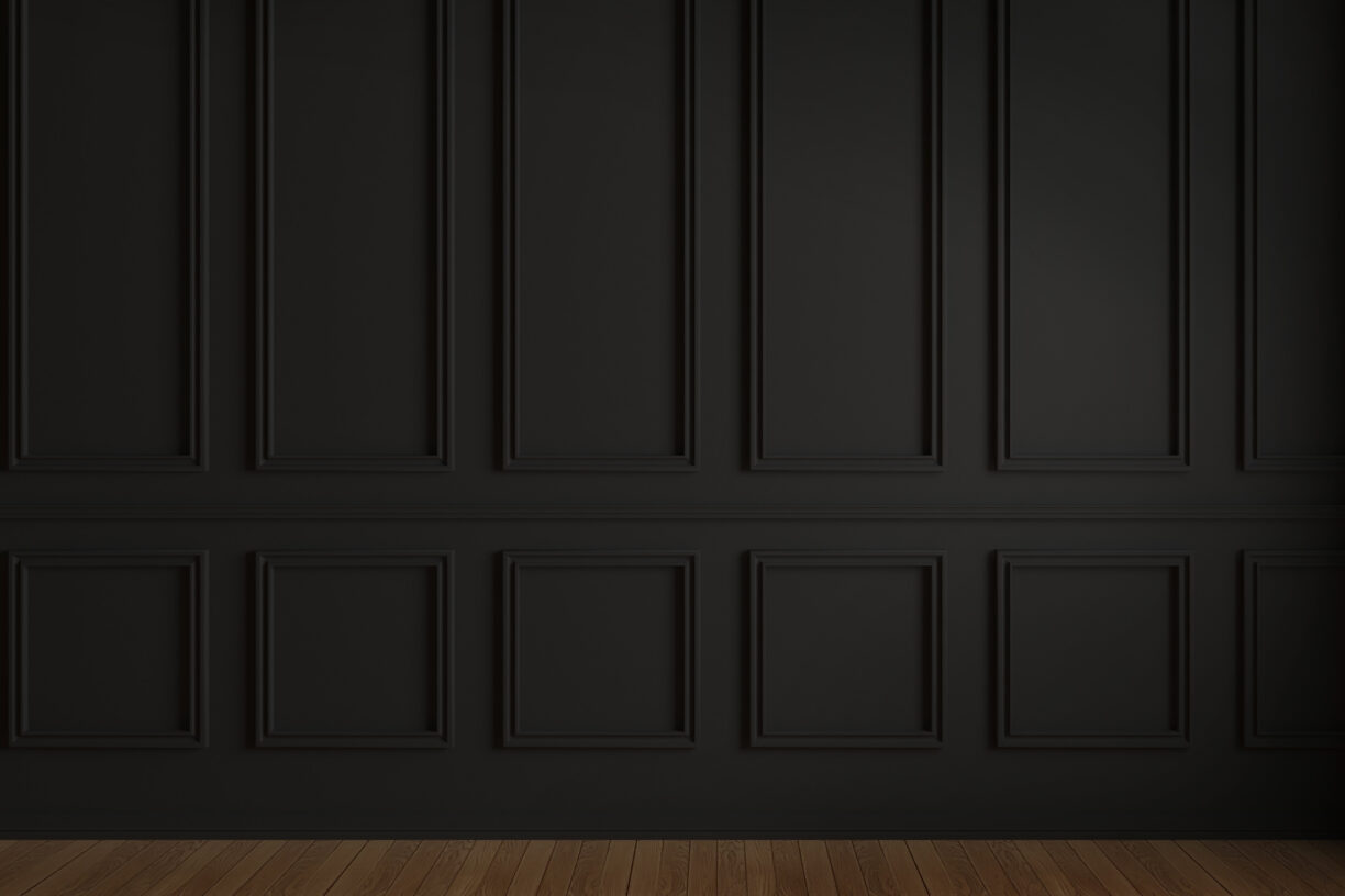 Black walls with vintage style wainscoting from floor to ceiling. 