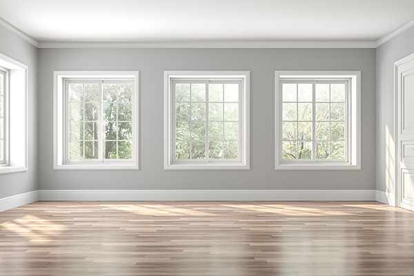 An image of windows on a gray wall with white casing
