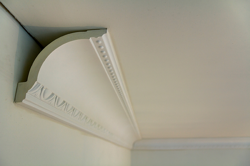 An image of a decorative, curved piece of white moulding