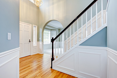 An image of a stairway with blue walls and white chair rail and moulding.