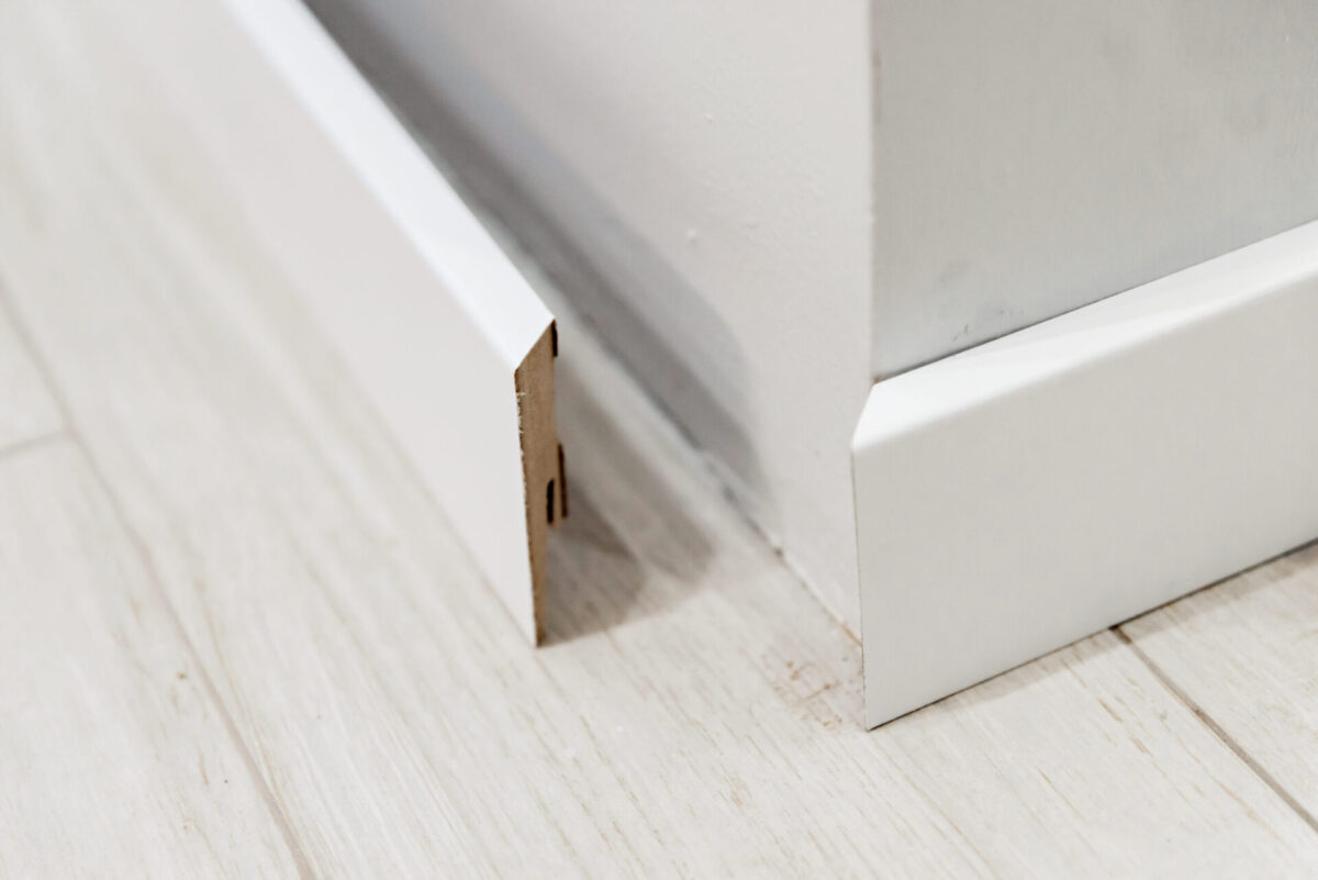 Two pieces of flat base moulding come together at a corner.