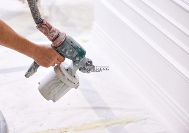 White modern baseboards and MDF crown molding freshly painted for a smooth, clean finish