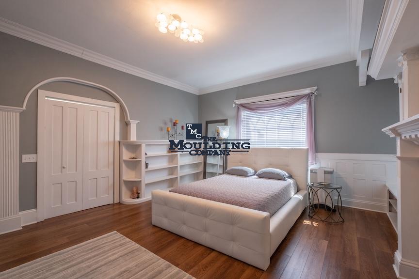 cozy bedroom interior with baseboard and crown moulding