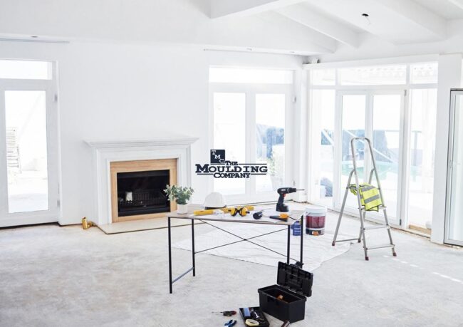 Interior remodel showing removed baseboards and door casings before trim replacement