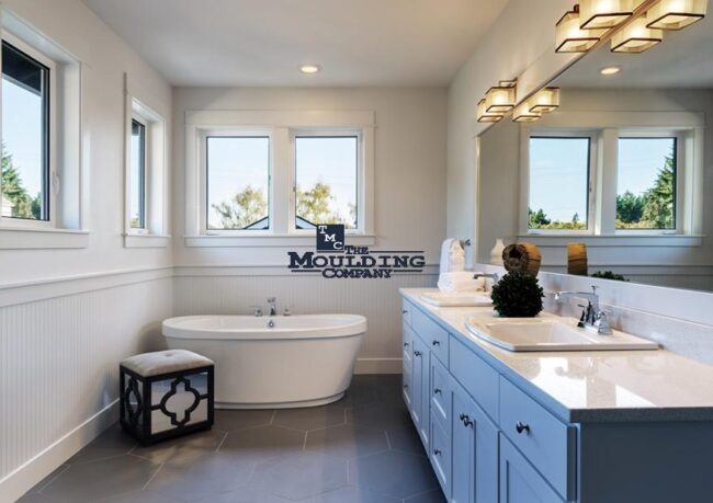 Bathroom and kitchen with moisture-resistant baseboards, crown moulding, and door casings