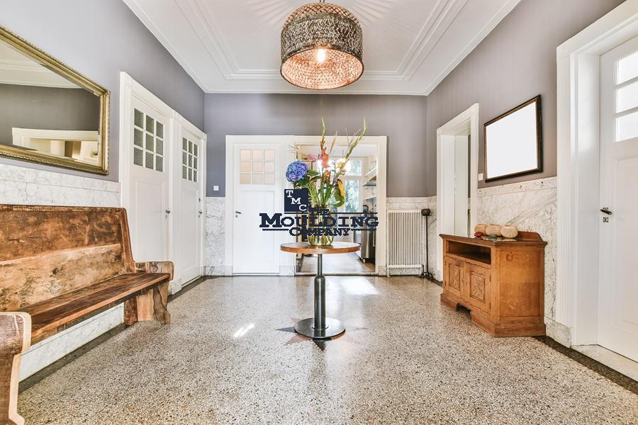 Elegant interior with decorative molding and classic furnishings.