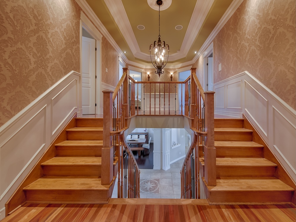 Staircase with custom wood molding and elegant design, showcasing high-quality craftsmanship.