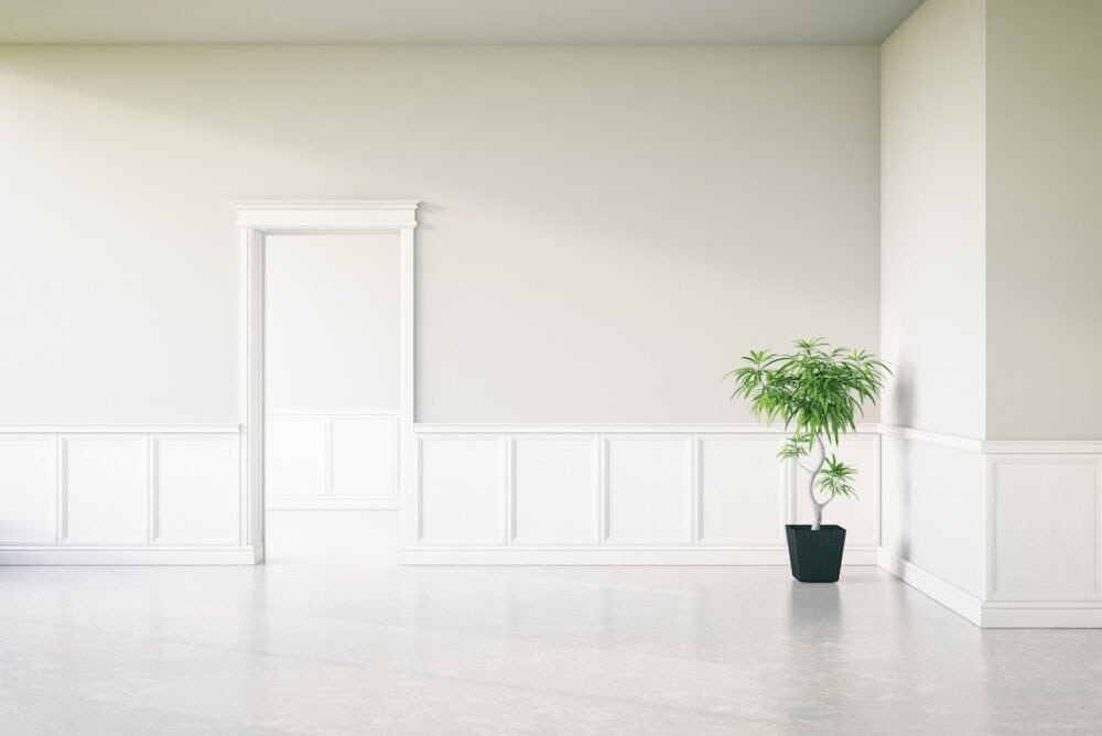 Interior wall with Moulding Company logo and decorative wainscoting.