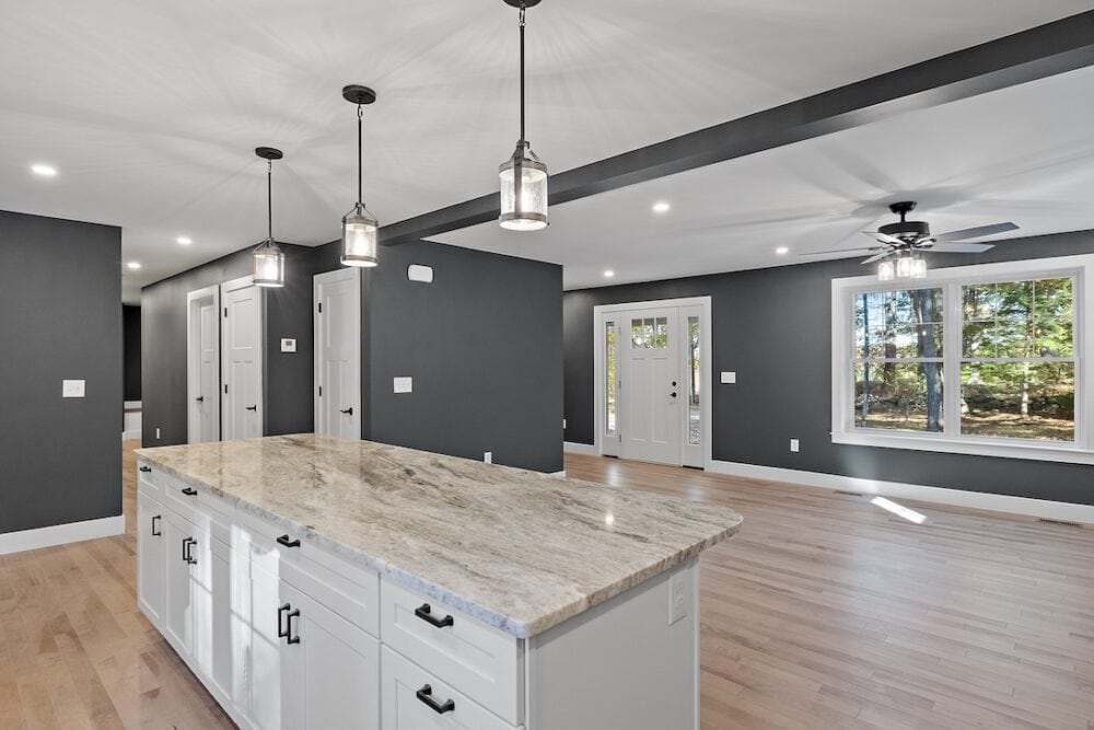 Modern interior featuring decorative moulding and a spacious kitchen island in a contemporary home.