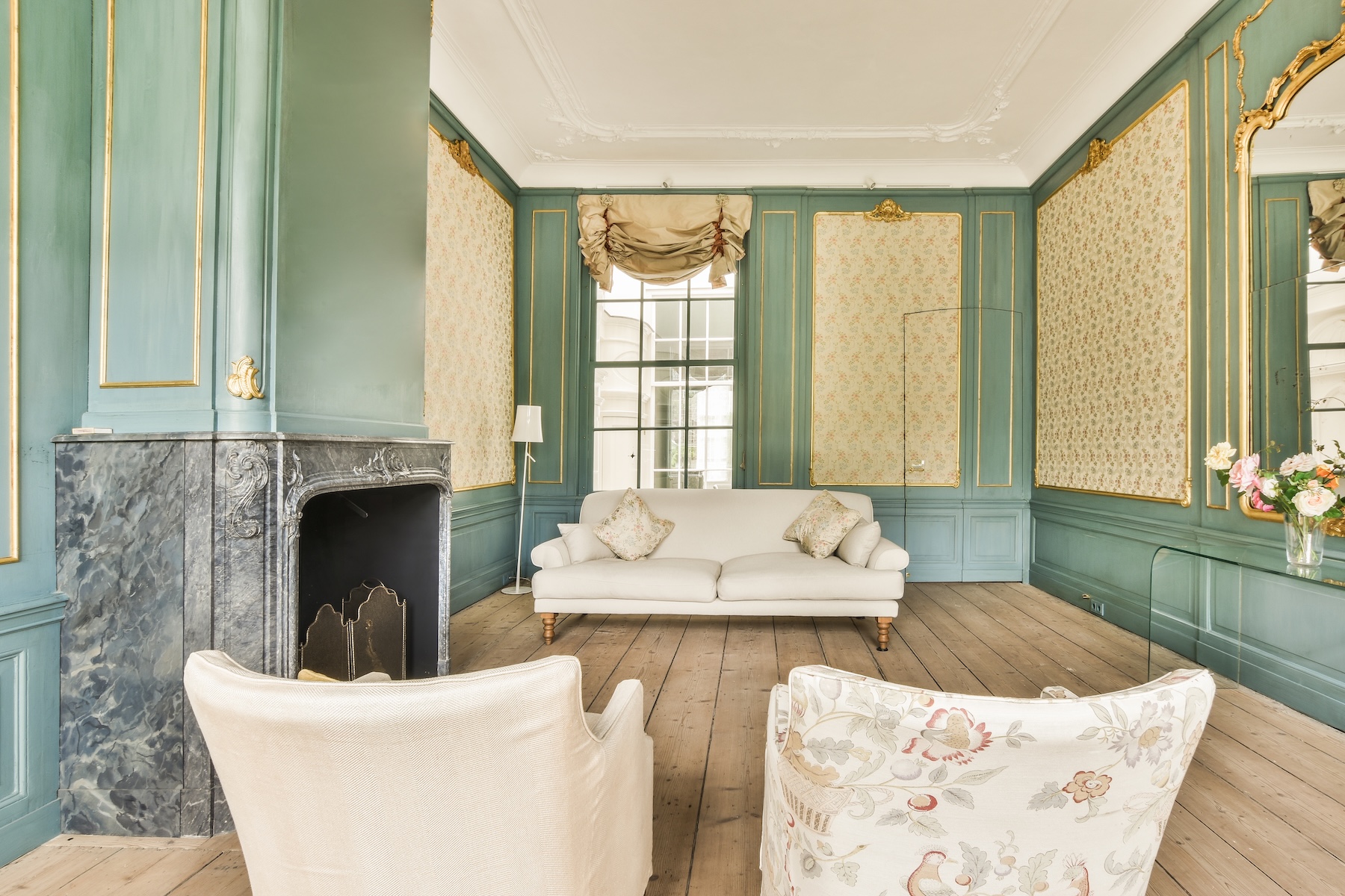 Luxury interior featuring high-end trim, crown moulding, wall panels, and custom door casings