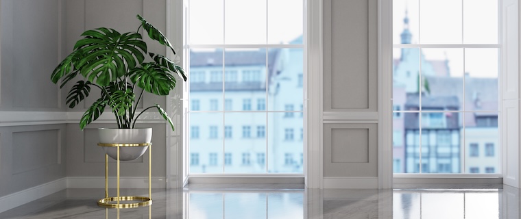 The Moulding Company logo displayed on a glass window in a bright room.