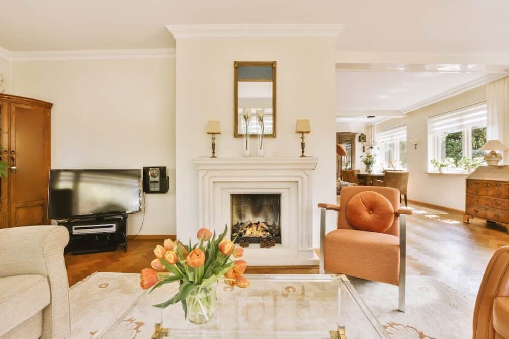 Stylish living room with fireplace, TV, and elegant moulding details.