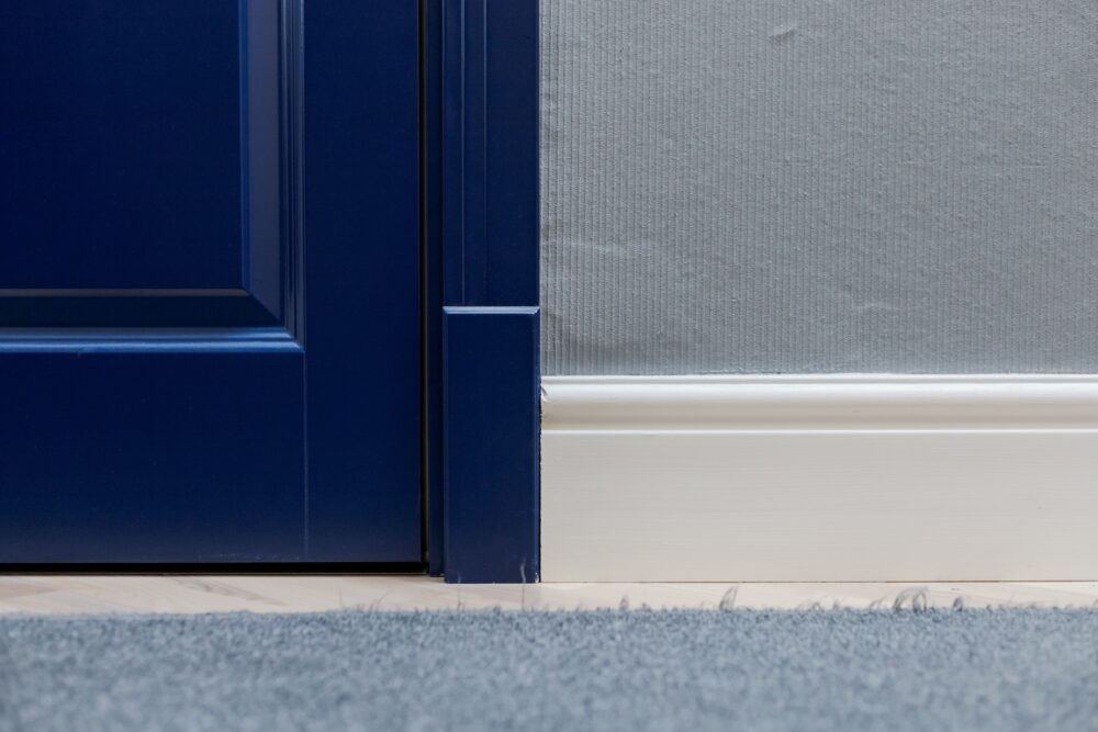 Door casing with a plinth block at the base and a rosette at the top corner