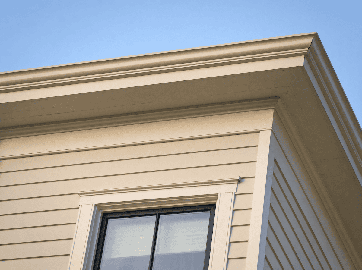 Exterior cornice with crown, bed moulding and frieze board at the eave of a painted Victorian home