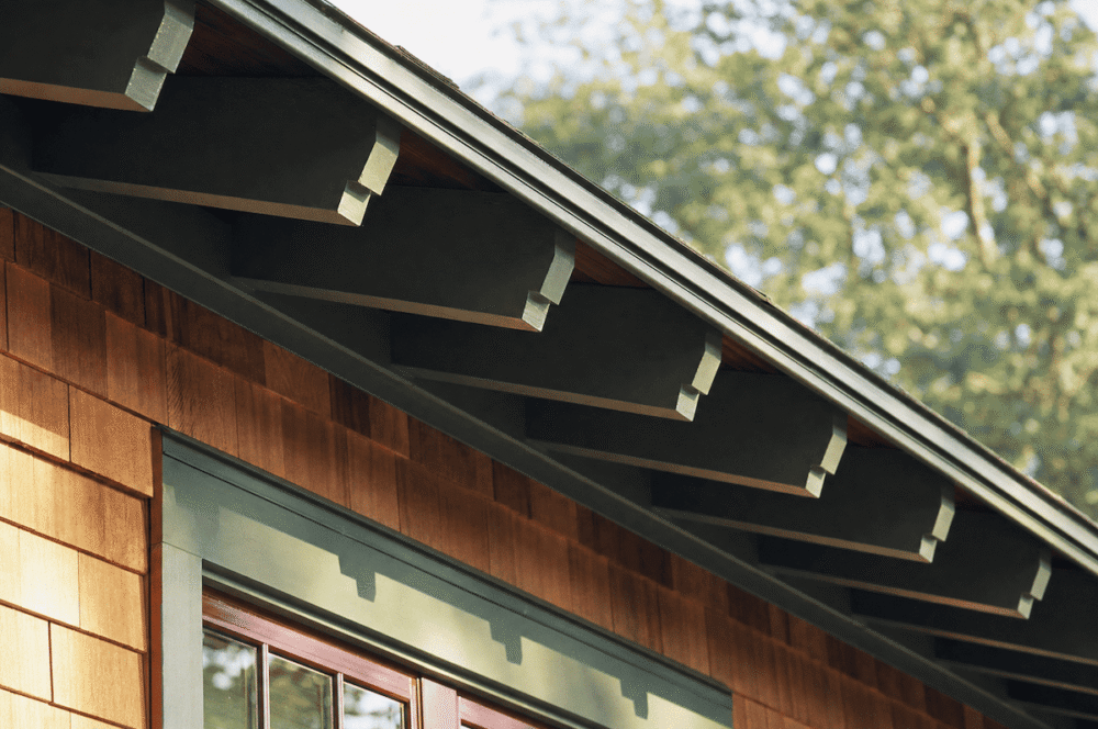 Open cornice with exposed rafter tails on a Craftsman home eave