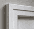 Backband fitted to the outer edge of painted door casing, raking light showing the shadow line it creates