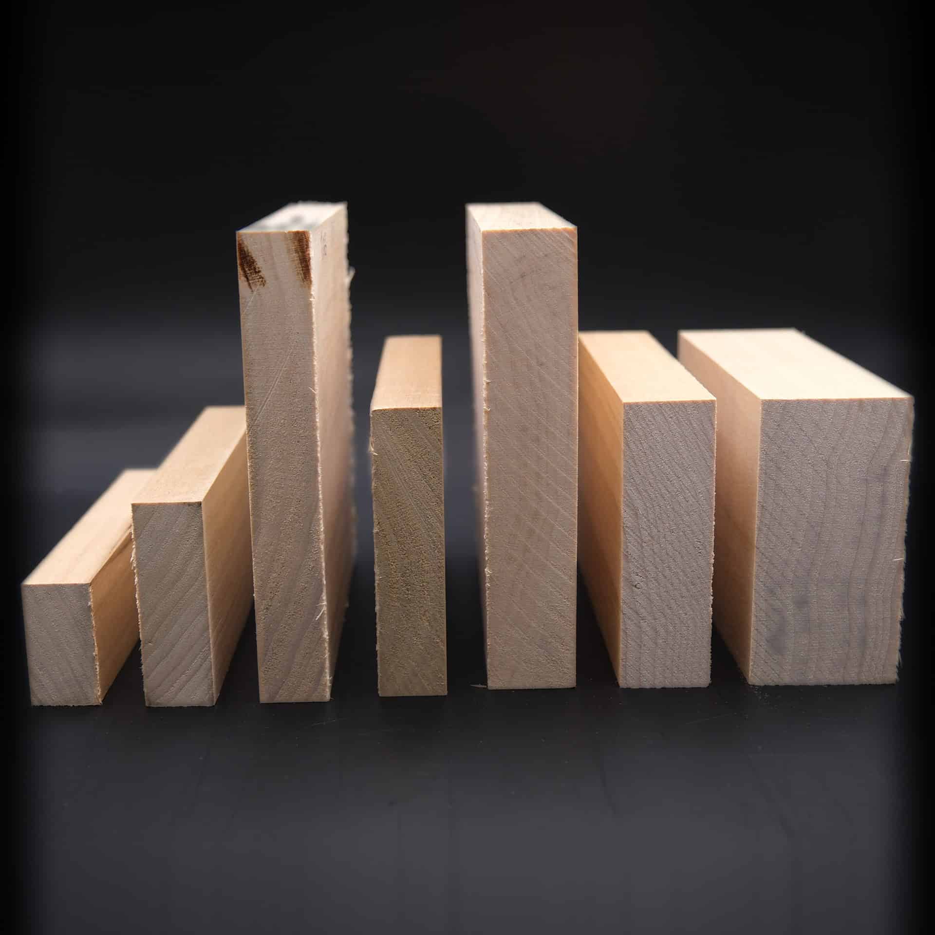 Stack of milled trim boards in several species showing different thicknesses